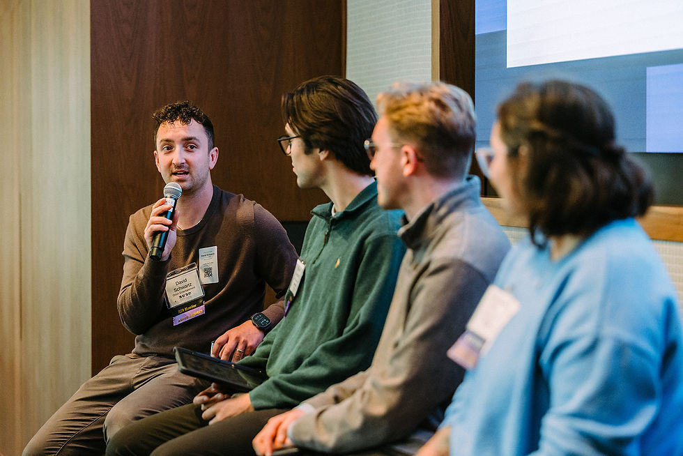 Close-up view of a seminar room with a speaker presenting slides to an engaged audience